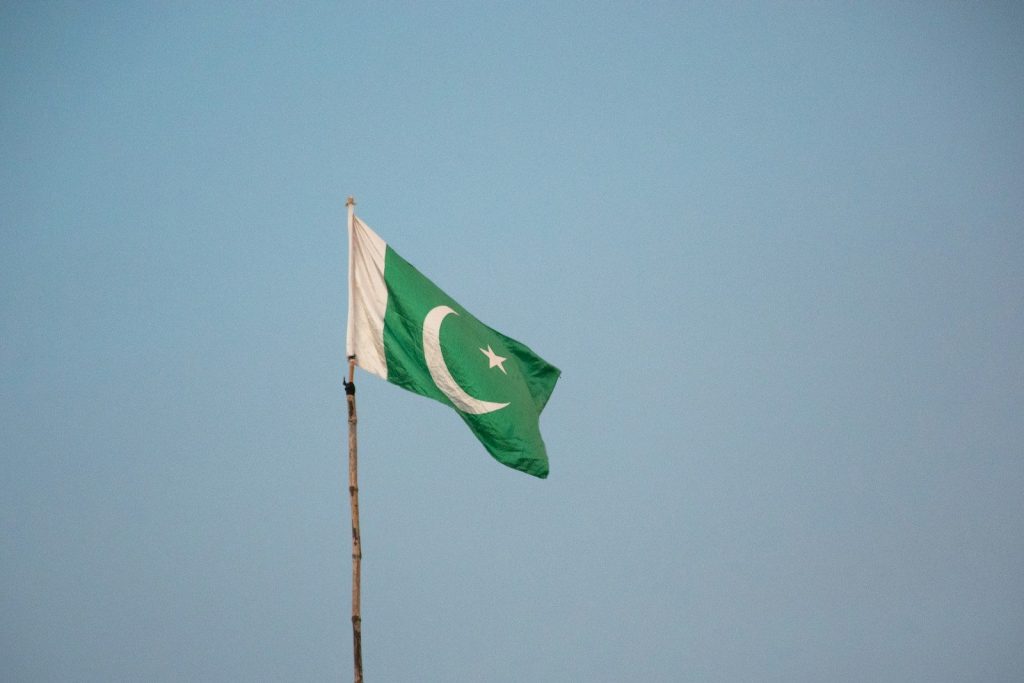 green flag on pole under blue sky during daytime